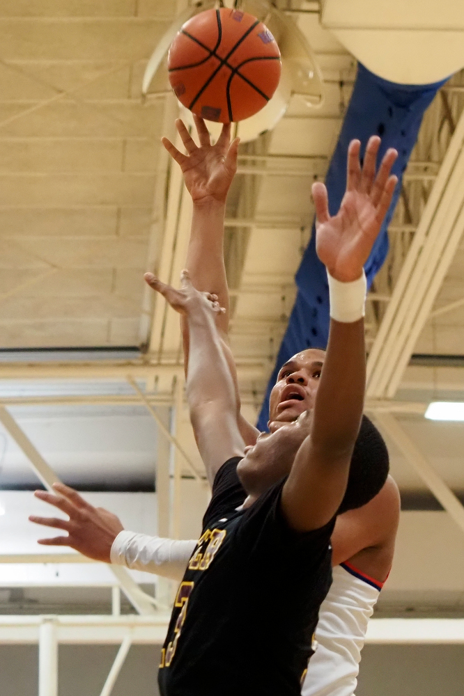 Staff photo by C.B. Schmelter / Red Bank's Cam Bell (1) throws up a shot against Tyner's Keelan Jackson (13) at Susan Ingram Thurman Gymnasium on the campus of Red Bank High School on Thursday, Jan. 21, 2021 in Chattanooga, Tenn.