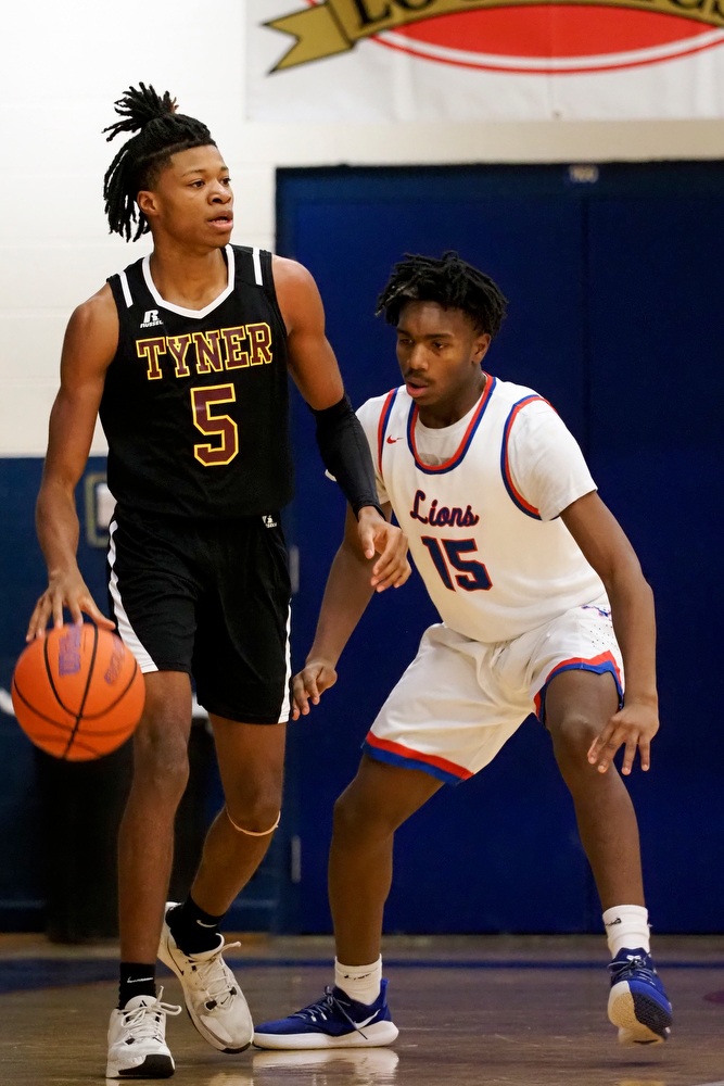Staff photo by C.B. Schmelter / Tyner's Javontay Ross (5) handles the ball as he is defended by Red Bank's Kendrick Loyd (15) at Susan Ingram Thurman Gymnasium on the campus of Red Bank High School on Thursday, Jan. 21, 2021 in Chattanooga, Tenn.