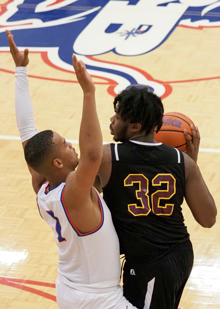 Staff photo by C.B. Schmelter / Tyner's Anthony Sims (32) works against Red Bank's Cam Bell (1) at Susan Ingram Thurman Gymnasium on the campus of Red Bank High School on Thursday, Jan. 21, 2021 in Chattanooga, Tenn.