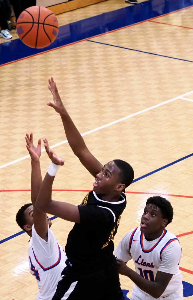 Staff photo by C.B. Schmelter / Tyner's Keelan Jackson (13) throws up a shot against Red Bank at Susan Ingram Thurman Gymnasium on the campus of Red Bank High School on Thursday, Jan. 21, 2021 in Chattanooga, Tenn.