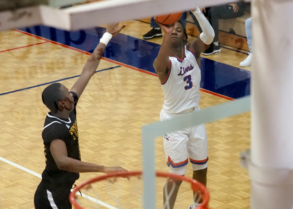 Staff photo by C.B. Schmelter / Red Bank's Kel Eddins (3) takes a shot against Tyner's Keelan Jackson (13) at Susan Ingram Thurman Gymnasium on the campus of Red Bank High School on Thursday, Jan. 21, 2021 in Chattanooga, Tenn.