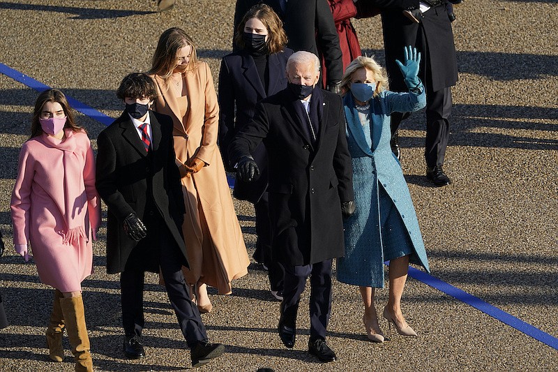 President Joe Biden and his wife Jill Biden walk in a parade during the Presidential Escort, part of Inauguration Day ceremonies, Wednesday, Jan. 20, 2021, in Washington. (AP Photo/David J. Phillip)