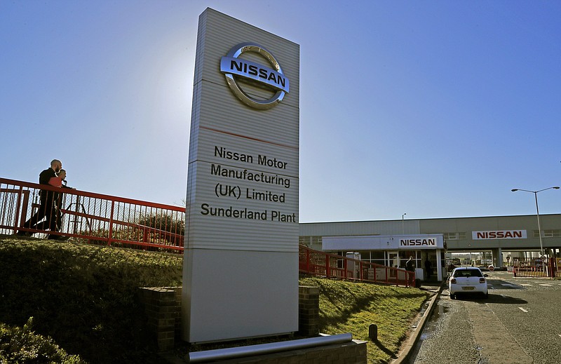 FILE - In this Thursday, March 14, 2019 file photo, workers walk toward the car builders Nissan plant in Sunderland, England. Japanese carmaker Nissan confirmed Friday, Jan. 22, 2021, that it will maintain its operations in Britain in the wake of the post-Brexit trade deal between the country and the European Union. The news was greeted by British Prime Minister Boris Johnson as a "great vote of confidence." (AP Photo/Frank Augstein, File)