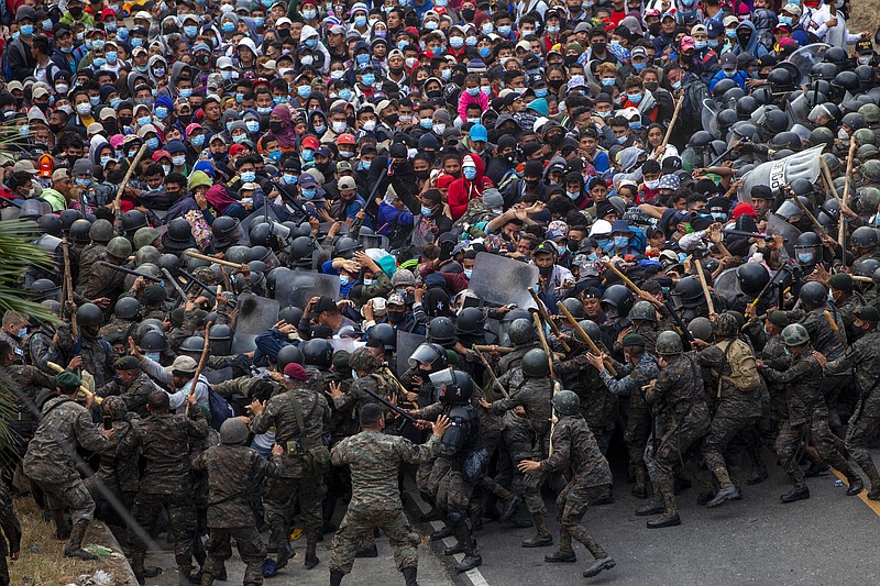 Photo by Sandra Sebastian of The Associated Press / Honduran migrants clash with Guatemalan soldiers in Vado Hondo, Guatemala, on Sunday, Jan. 17, 2021. Guatemalan authorities estimated that as many as 9,000 Honduran migrants crossed into Guatemala as part of an effort to form a new caravan to reach the U.S. border.
