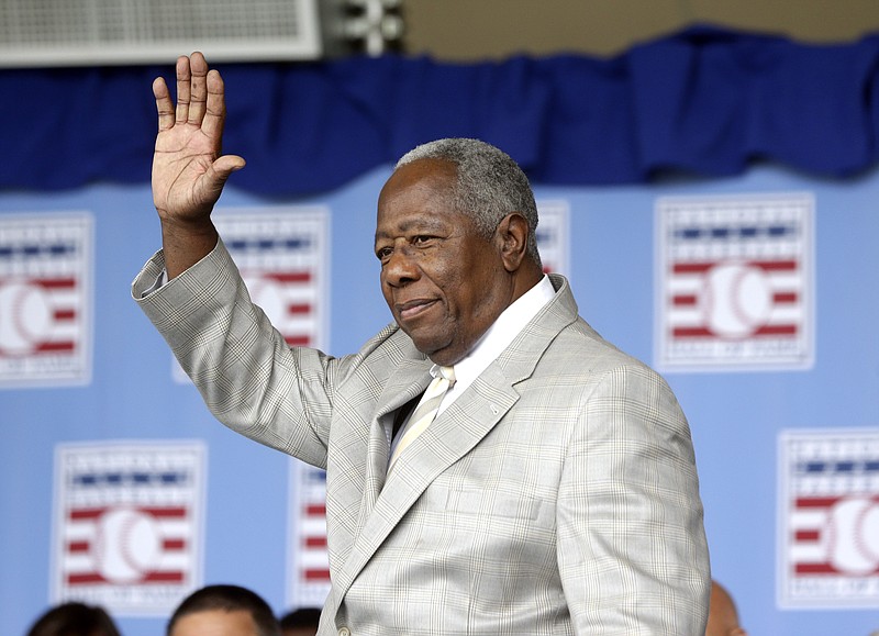 AP photo by Mike Groll / Atlanta Braves great Hank Aaron waves to the crowd during National Baseball Hall of Fame induction ceremonies on July 28, 2013, in Cooperstown, N.Y. Aaron, the former all-time MLB home run leader who shook off others' bigotry to star in his native Deep South, died Friday at age 86.