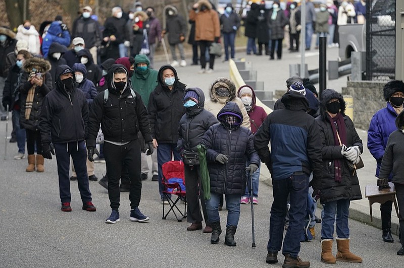 People wait in line for the COVID-19 vaccine in Paterson, N.J., Thursday, Jan. 21, 2021. The first people arrived around 2:30 a.m. for the chance to be vaccinated at one of the few sites that does not require an appointment. (AP Photo/Seth Wenig)


