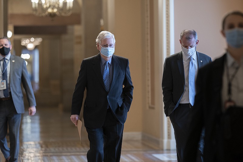 On the first full day of the new Democratic majority in the Senate, Sen. Mitch McConnell, R-Ky., the top Republican, walks to the chamber for the start of business as the minority leader, at the Capitol in Washington, Thursday, Jan. 21, 2021. There is now a 50-50 split between Republicans and Democrats, but with Democratic Vice President Kamala Harris as the tie-breaker, the majority shifts by the slimmest of margins. (AP Photo/J. Scott Applewhite)