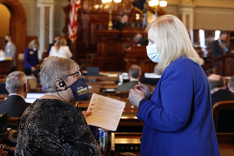 Kansas state Reps. Brenda Landwehr, left, R-Wichita, and Susan Concannon, R-Beloit, confer during a House debate on a proposed anti-abortion amendment to the Kansas Constitution, Friday, Jan. 22, 2021, at the Statehouse in Topeka, Kan. Both supported the measure, which would overturn a Kansas Supreme Court decision in 2019 that declared access to abortion a "fundamental" right under the state constitution. (AP Photo/John Hanna, Pool)


