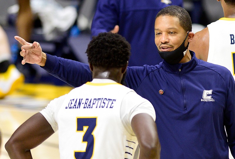 Staff photo by Robin Rudd /UTC coach Lamont Paris speaks to senior David Jean-Baptiste during Saturday's 74-66 loss to UNC Greensboro at McKenzie Arena. The Mocs dropped to 12-5 overall and 3-5 in SoCon play.