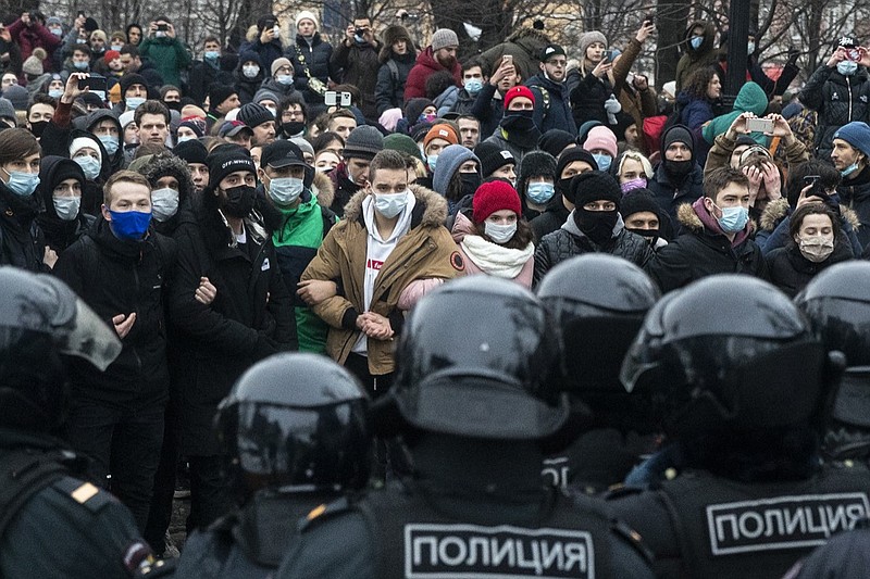 People stand in front of police officers during a protest against the jailing of opposition leader Alexei Navalny in Moscow, Russia, Saturday, Jan. 23, 2021. Russian police on Saturday arrested hundreds of protesters who took to the streets in temperatures as low as minus-50 C (minus-58 F) to demand the release of Alexei Navalny, the country's top opposition figure. (AP Photo/Pavel Golovkin)
