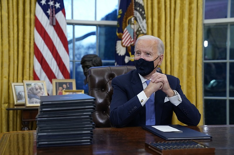 FILE - In this Jan. 20, 2021, file photo President Joe Biden waits to sign his first executive order in the Oval Office of the White House in Washington. As one of his first acts, Biden offered a sweeping immigration overhaul that would provide a path to U.S. citizenship for the estimated 11 million people who are in the United States illegally. It would also codify provisions wiping out some of President Donald Trump's signature hard-line policies, including trying to end existing, protected legal status for many immigrants brought to the U.S. as children and crackdowns on asylum rules. (AP Photo/Evan Vucci, File)