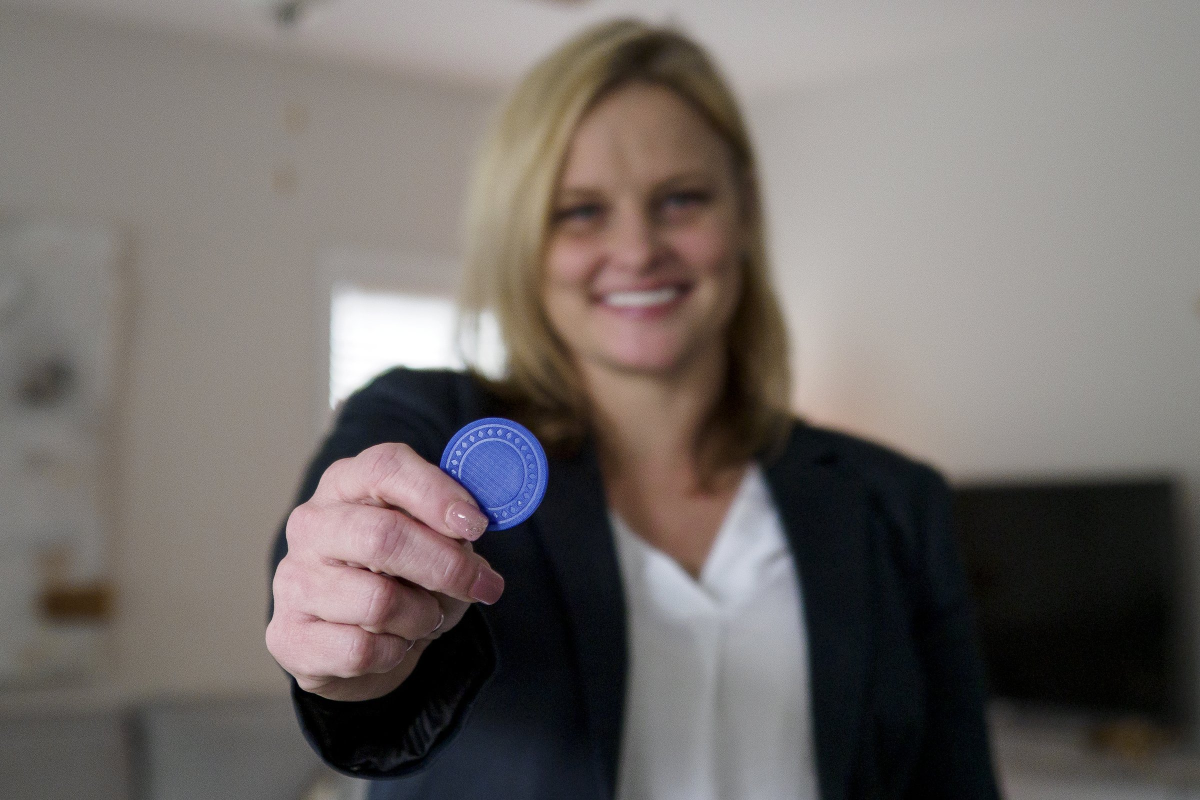 Staff photo by C.B. Schmelter / Ashley Harrison poses with her 6-month chip at The Launch Pad, a sober-living home for women founded by local restaurateur Scottie Bowman.