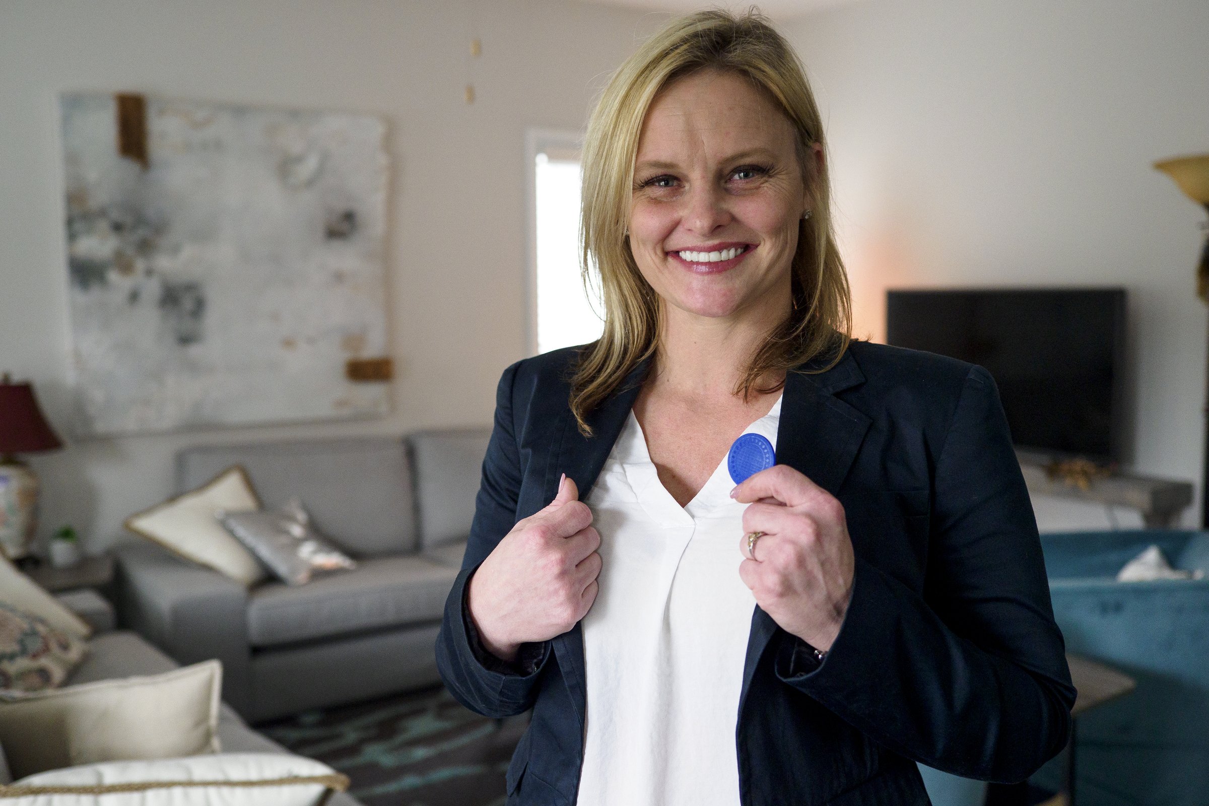 Staff photo by C.B. Schmelter / The Launch Pad resident Ashley Harrison shows off her chip marking 6 months of sobriety.