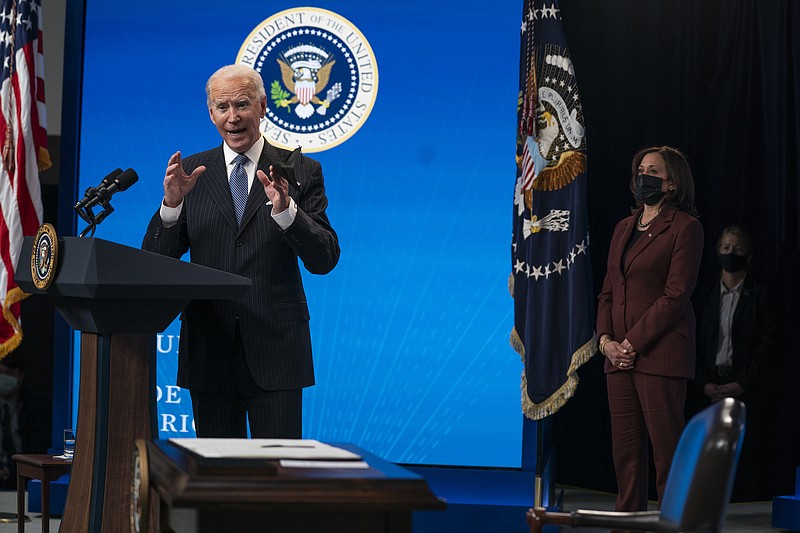 Vice President Kamala Harris listens as President Joe Biden answers questions from reporters in the South Court Auditorium on the White House complex, Monday, Jan. 25, 2021, in Washington, as Vice President Kamala Harris listens. (AP Photo/Evan Vucci)