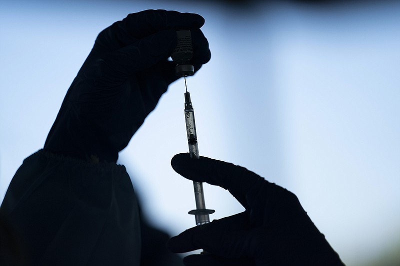 The Associated Press / A medical staff member prepares the Pfizer-BioNTech COVID-19 vaccine at Tudor Ranch in Mecca, California, last week.