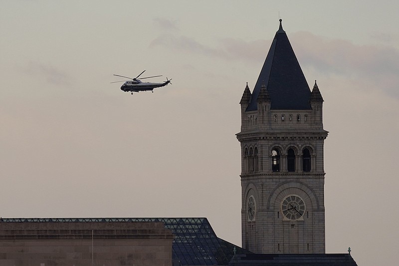 Marine One with President Donald Trump aboard flies over Washington and the Trump International Hotel during Inauguration Day ceremonies, Wednesday, Jan. 20, 2021. Trump is en route to his Mar-a-Lago Florida Resort.(AP Photo/Carolyn Kaster)