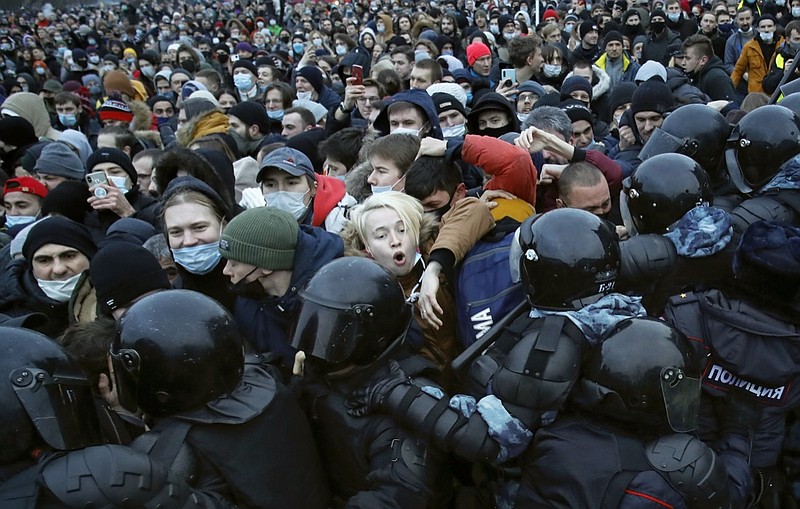 FILE - In this Jan. 23, 2021, file photo, people clash with police during a protest against the jailing of opposition leader Alexei Navalny in St. Petersburg, Russia. Allies of Navalny are calling for new protests next weekend to demand his release, following a wave of demonstrations across the country that brought out tens of thousands in a defiant challenge to President Vladimir Putin. (AP Photo/Dmitri Lovetsky, File)