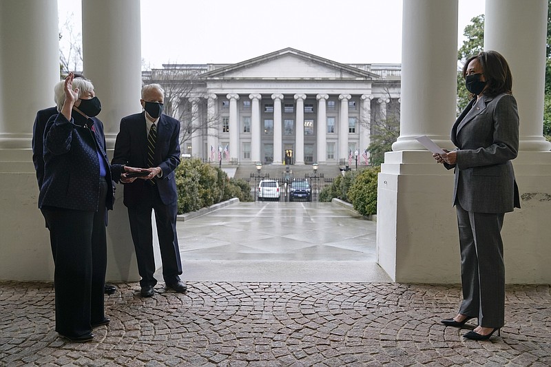 Vice President Kamala Harris participates in a swearing-in ceremony with Treasury Secretary Janet Yellen and Yellen's husband George Akerlof, Tuesday, Jan. 26, 2021, at the White House in Washington. The Treasury building stands behind. (AP Photo/Patrick Semansky)