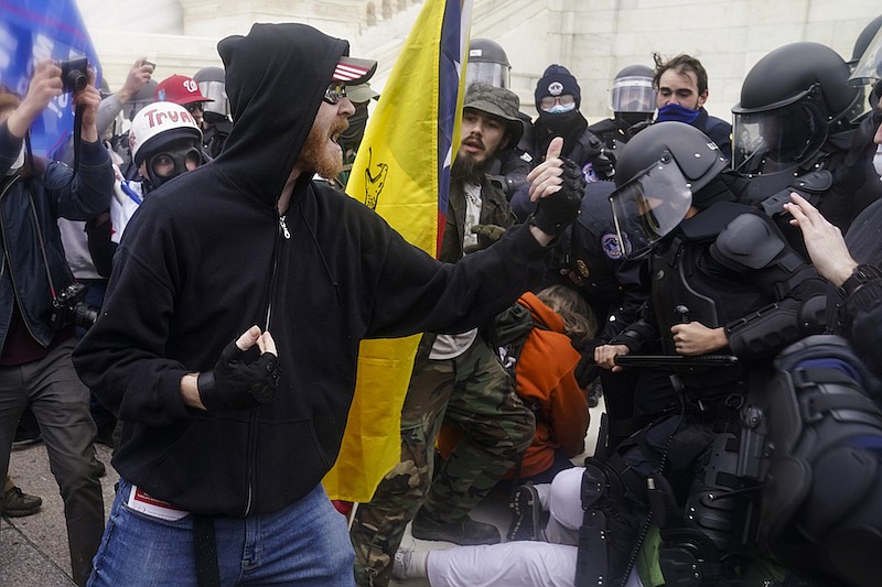 In this Jan. 6, 2021, file photo, Trump supporters try to break through a police barrier at the Capitol in Washington. In dozens of cases on social media, Trump supporters downright flaunted their activity on the day of the deadly insurrection. Some, apparently realizing they were in trouble with the law, deleted their accounts only to discover their friends and family members had already taken screenshots of their selfies, videos and comments and sent them to the FBI. (AP Photo/John Minchillo, File)