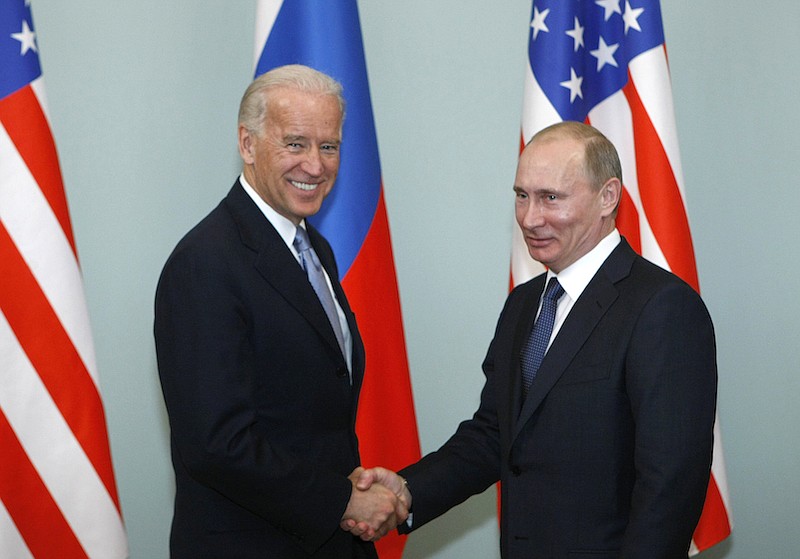 In this March 10, 2011, file photo, then-Vice President Joe Biden, left, shakes hands with Russian Prime Minister Vladimir Putin in Moscow, Russia. President Joe Biden has been thrown into a high-wire act with Russia as he seeks to toughen his administration's stance against Putin while preserving room for diplomacy in a post-Donald Trump era. (AP Photo/Alexander Zemlianichenko, File)