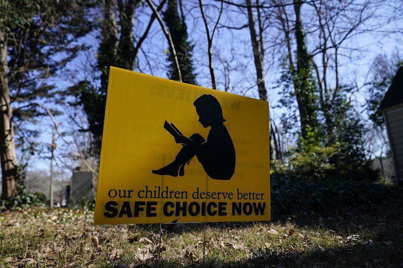 A sign that reads "our children deserve better safe choice now" is seen on Friday, Jan. 15, 2021, in Decatur, Ga. (AP Photo/Brynn Anderson)


