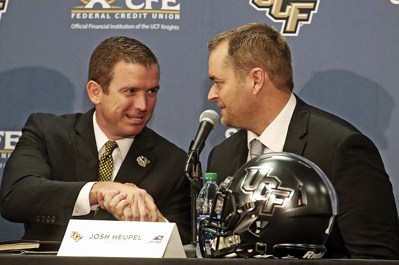 Orlando Sentinel photo by Red Huber via AP / Josh Heupel, right, is introduced as the new head football coach for the University of Central Florida by Danny White, the school's athletic director, on Dec. 5, 2017, in Orlando. Now both Heupel and White are at Tennessee in the same positions, with White's hire as AD announced by the Vols last week and Heupel introduced as the Knoxville's program's 27th coach in its history on Wednesday.