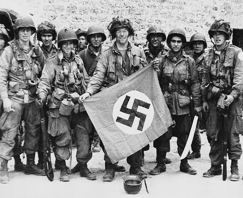 Associated Press File Photo / American paratroopers display a Nazi flag captured after they made a successful landing behind the German lines on the Normandy coast of France on June 9, 1944, but columnist Ron Hart wonders if Nazi tactics are now being practiced here.