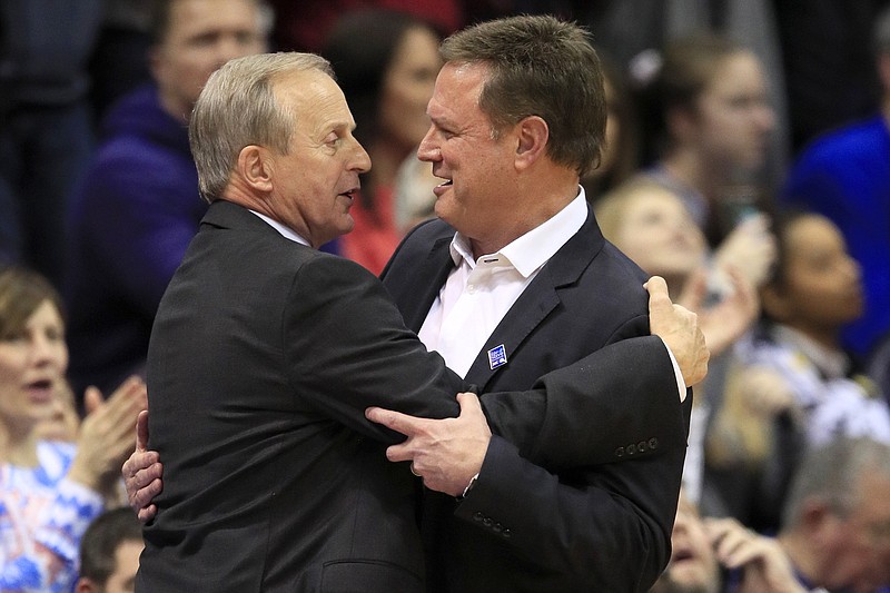 AP photo by Orlin Wagner / Tennessee men's basketball coach Rick Barnes, left, hugs Kansas counterpart Bill Self, right, after their teams met in a Big 12/SEC Challenge game on Jan. 25, 2020, in Lawrence, Kan. Kansas won 74-68, and now the Jayhawks are set to visit Knoxville on Saturday for a rematch.