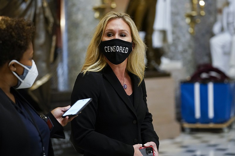 AP File Photo by Susan Walsh/Rep. Marjorie Taylor Greene, R-Ga., walks on Capitol Hill in Washington, on Jan. 13, 2021, wearing a mask that reads "censored."