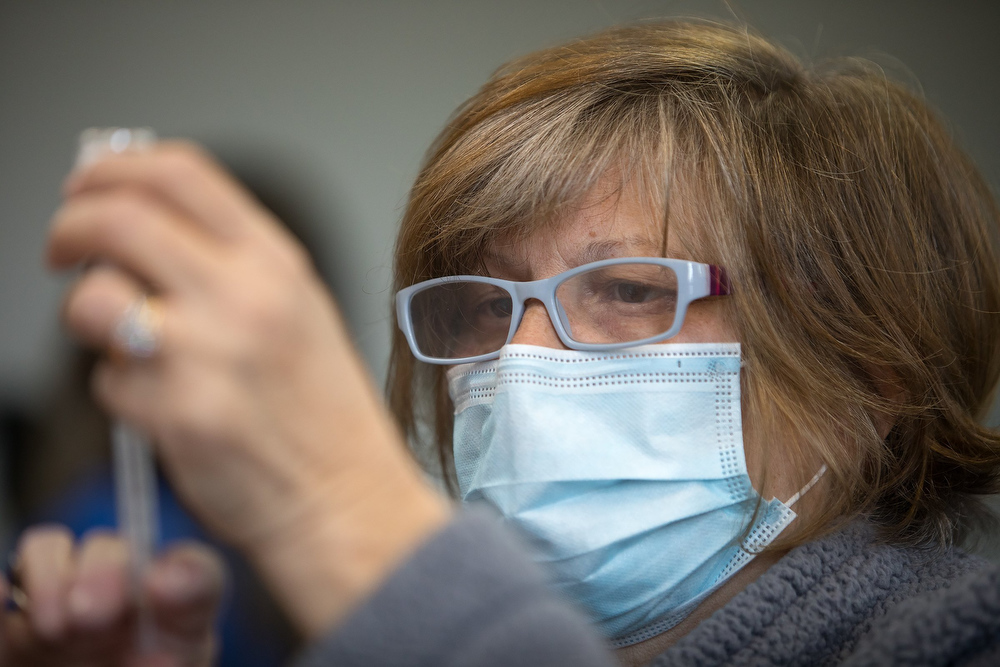 Staff photo by Troy Stolt / Sue Mason fills a syringe with a dose of the Moderna COVID-19 vaccine inside of the pharmacy station at the Hamilton County Health Department's new COVID Vaccination POD at the CARTA Bus Terminal on Thursday, Jan. 28, 2021 in Chattanooga, Tenn.