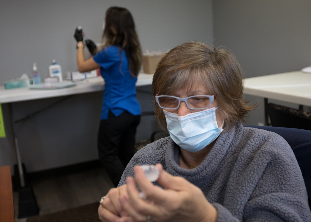 Staff photo by Troy Stolt / Sue Mason and Lauren Dean prepare doses of the Moderna COVID-19 vaccine inside the pharmacy area at the Hamilton County Health Department's new COVID Vaccination POD at the CARTA Bus Terminal on Thursday, Jan. 28, 2021 in Chattanooga, Tenn.