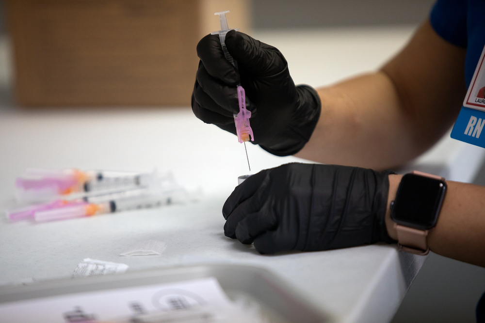 Staff photo by Troy Stolt / RN Lauren Dean fills syringes with the Moderna COVID-19 vaccine inside of the pharmacy at the Hamilton County Health Department's new COVID Vaccination POD at the CARTA Bus Terminal on Thursday, Jan. 28, 2021 in Chattanooga, Tenn.