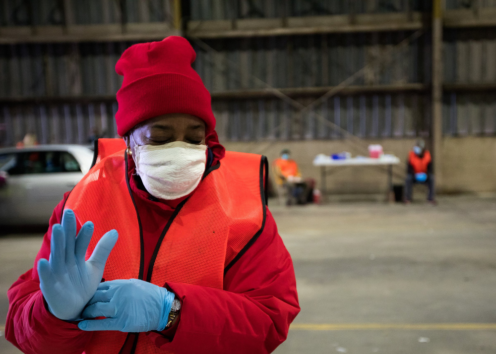 Staff photo by Troy Stolt / Aleta Bray, an RN volunteer from the Medical Reserve Corps changes gloves before administering the Moderna COVID-19 vaccine at the Hamilton County Health Department's new COVID Vaccination POD at the CARTA Bus Terminal on Thursday, Jan. 28, 2021 in Chattanooga, Tenn.