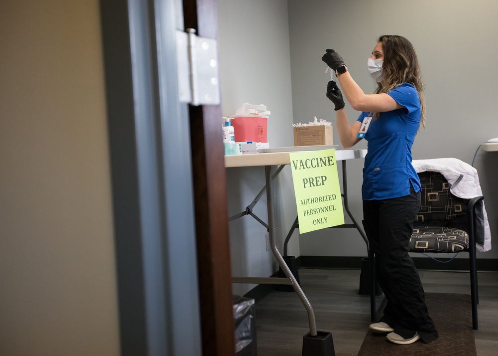 Staff photo by Troy Stolt / RN Lauren Dean fills syringes with the Moderna COVID-19 vaccine inside of the pharmacy at the Hamilton County Health Department's new COVID Vaccination POD at the CARTA Bus Terminal on Thursday, Jan. 28, 2021 in Chattanooga, Tenn.