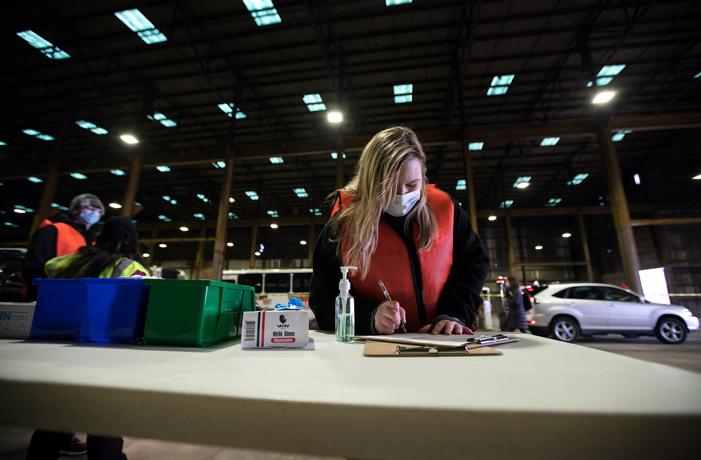 Staff photo by Troy Stolt / LPN Kristin Dinus looks through paperwork before administering the Moderna COVID-19 vaccine to a patient at the Hamilton County Health Department's new COVID Vaccination POD at the CARTA Bus Terminal on Thursday, Jan. 28, 2021 in Chattanooga, Tenn.
