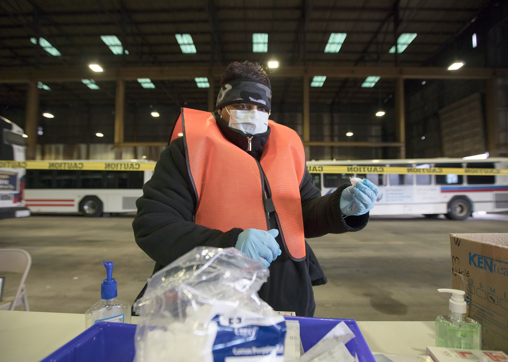 Staff photo by Troy Stolt / LPN Adrian Price prepares a dose of the Moderna COVID-19 vaccine at the Hamilton County Health Department's new COVID Vaccination POD at the CARTA Bus Terminal on Thursday, Jan. 28, 2021 in Chattanooga, Tenn.