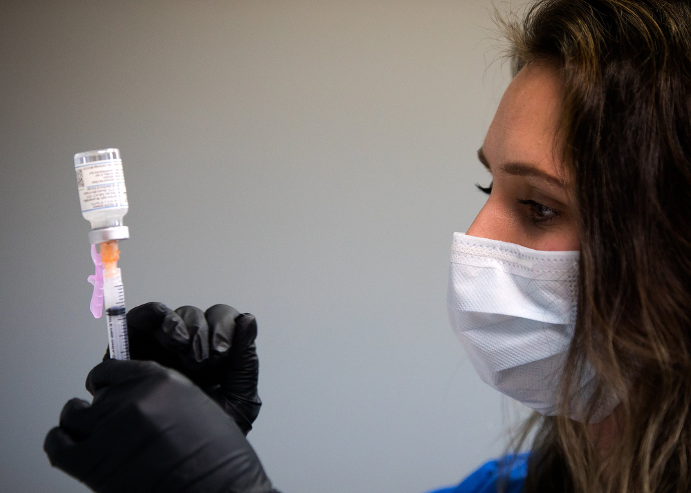 Staff photo by Troy Stolt / RN Lauren Dean fills syringes with the Moderna COVID-19 vaccine inside of the pharmacy at the Hamilton County Health Department's new COVID Vaccination POD at the CARTA Bus Terminal on Thursday, Jan. 28, 2021 in Chattanooga, Tenn.