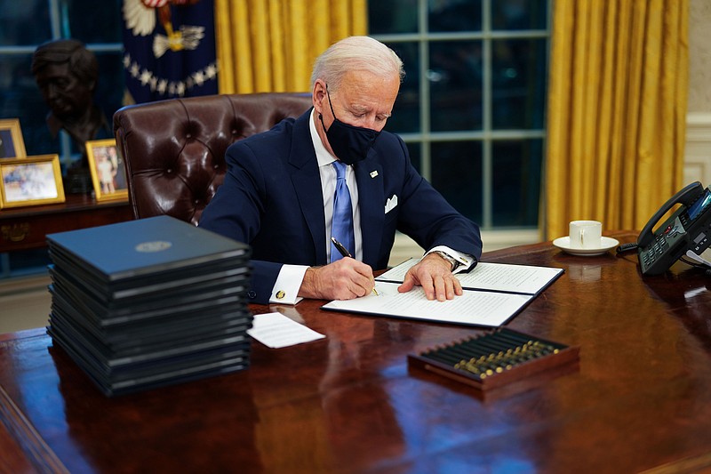 Photo by Doug Mills of The New York Times / President Joe Biden signs his first executive orders in the Oval Office of the White House in Washington on Wednesday, Jan. 20, 2021. Biden, vowing to restore environmental protections frayed over the past four years, has ordered the review of more than 100 rules and regulations on air, water, public lands, endangered species and climate change that were weakened or rolled back by his predecessor.