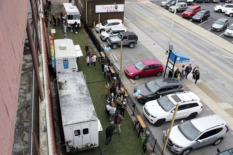 Staff photo by C.B. Schmelter / People mingle about during the soft opening at Food Truck Alley on Saturday, Jan. 30, 2021 in Chattanooga, Tenn.
