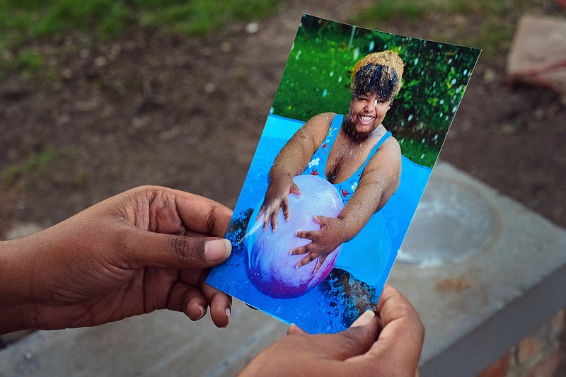 Staff photo by Wyatt Massey / Zapouria Lewis holds a photo of her daughter Nautika Lewis on Jan. 29, 2021 outside her Chattanooga home. Nautika, who had Prader-Willi syndrome, died of COVID-19 at age 20 in Nov. 2020.