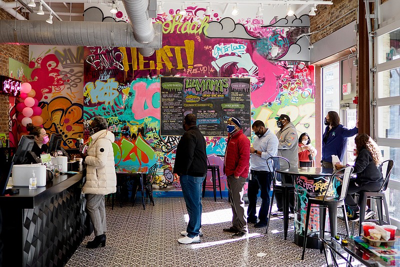 Staff photo by C.B. Schmelter / People wait in line to order at Lil Mama's Chicago Style Hoagy on Friday, Jan. 29, 2021 in Chattanooga, Tenn. Before opening Lil Mama's, Tiffany Banks used social media, with more than 2,200 Instagram and Facebook subscribers, to develop her brand.