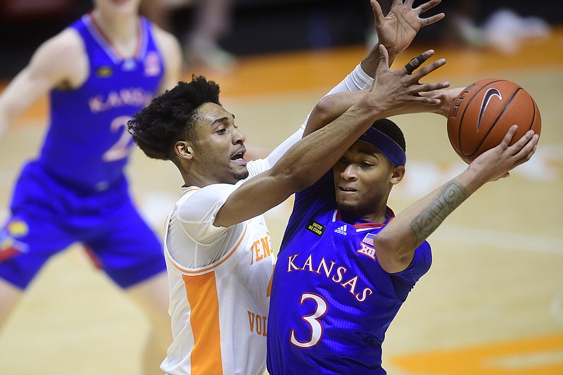 Knoxville News Sentinel photo by Caitie McMekin via AP / Tennessee guard Keon Johnson, left, tries to steal the ball from Kansas counterpart Dajuan Harris Jr. during their team's Big 12/SEC Challenge game Saturday night in Knoxville. Johnson helped the Vols cruise to a 19-point win.