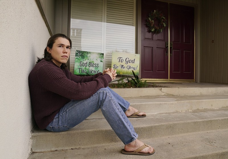 Hans Westenburg, a sophomore at UC-Irvine who is attending school remotely, poses for a portrait outside his family's home, Wednesday, Jan. 6, 2021, in Redlands, Calif. Westenburg is hopeful he can stay on track with his plans to become a physician though he worries that the quality of his education has deteriorated since classes went remote due to COVID-19.(AP Photo/Chris Pizzello)