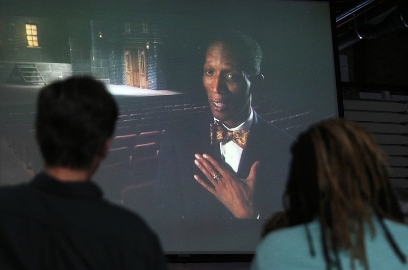 Staff file photo by Erin O. Smith / Guests watch a short documentary featuring LaFrederick Thirkill, a co-chair for the Ed Johnson Project, during a meeting at Green Spaces in June 2017. The project committee met with people interested in joining efforts to create a monument honoring Ed Johnson, a Chattanooga man who was falsely accused of rape and lynched in 1906 on the Walnut Street Bridge.