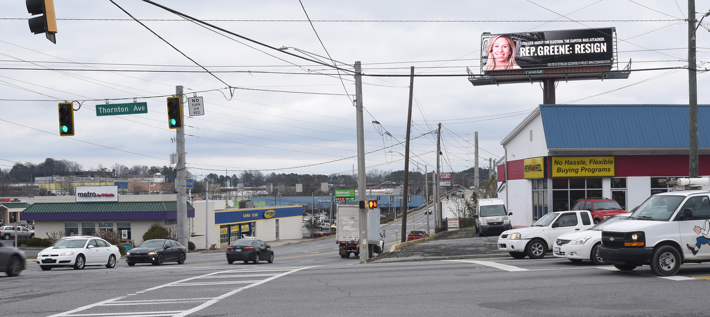 Staff Photo by Matt Hamilton / An electronic billboard at the intersection of Thornton and W. Walnut Avenues urges Rep. Marjorie Taylor Greene to resign on Monday, Feb. 1, 2021.