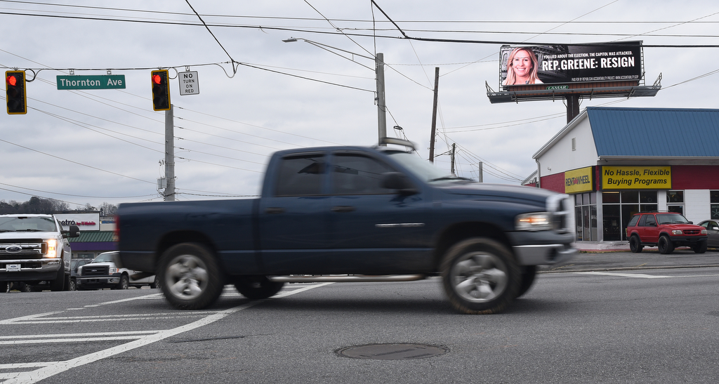 Staff Photo by Matt Hamilton / An electronic billboard at the intersection of Thornton and W. Walnut Avenues urges Rep. Marjorie Taylor Greene to resign on Monday, Feb. 1, 2021.