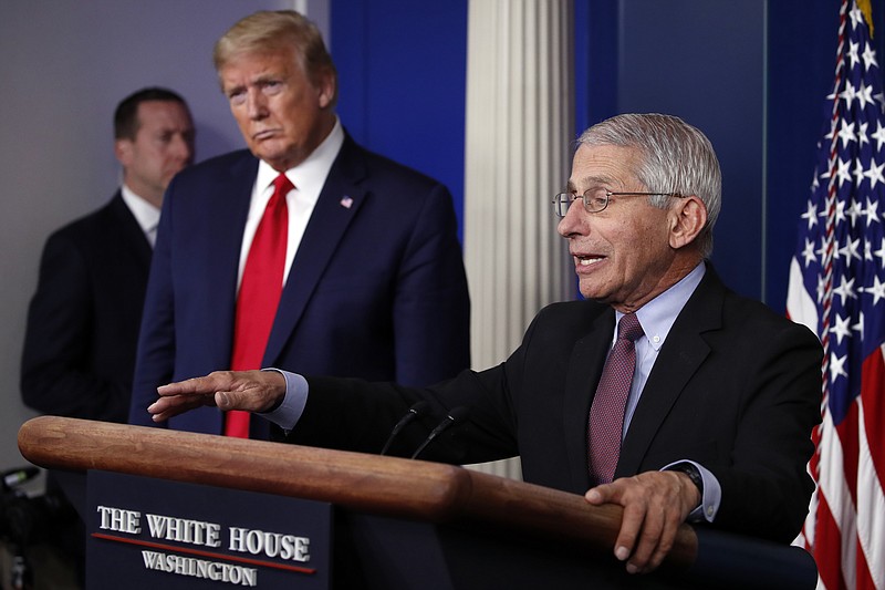 Associated Press File Photo / Then-President Donald Trump glares as Dr. Anthony Fauci, director of the National Institute of Allergy and Infectious Diseases, speaks about the coronavirus in the James Brady Press Briefing Room of the White House in Washington last April.