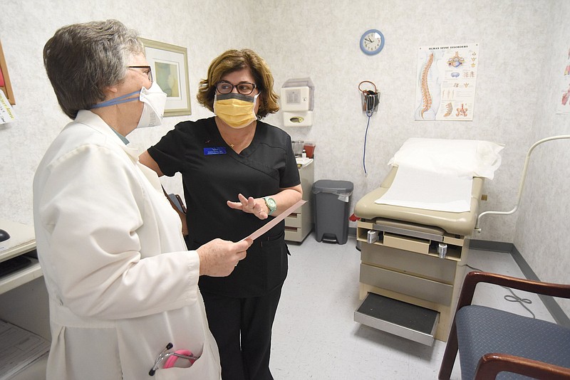 Staff Photo by Matt Hamilton / Family nurse practitioner Holly Gadd, left, talks to clinical nurse manager Laura Grody at Volunteers in Medicine on Tuesday, Jan. 26, 2021. 