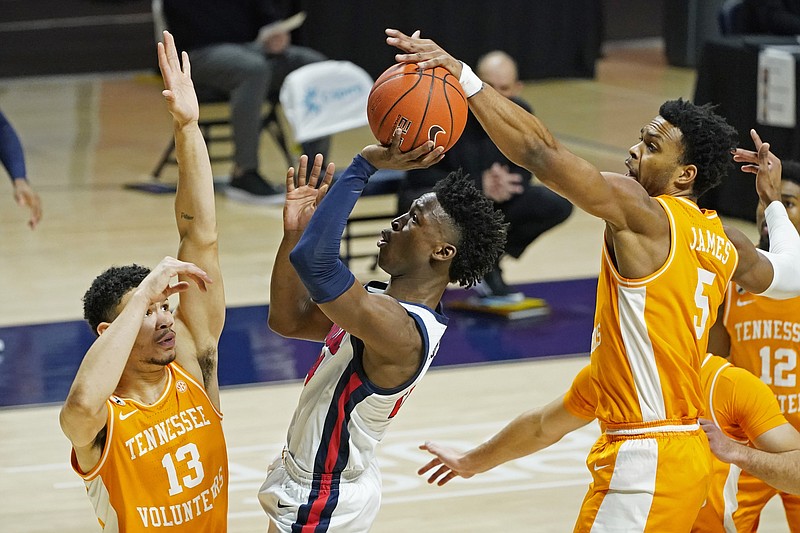 Mississippi guard Jarkel Joiner (24) has his shot blocked by Tennessee guard Josiah-Jordan James (5) and forward Olivier Nkamhoua (13) during the first half of an NCAA college basketball game in Oxford, Miss., Tuesday, Feb. 2, 2021. (AP Photo/Rogelio V. Solis)