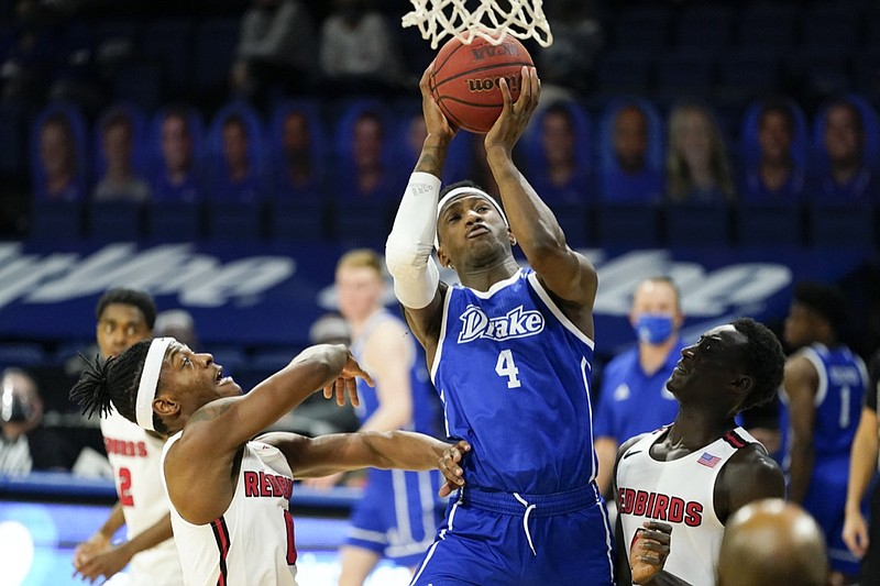 Drake forward ShanQuan Hemphill, center, drives to the basket between Illinois State guard DJ Horne, left, and forward Abdou Ndiaye, right, during the second half of an NCAA college basketball game, Monday, Feb. 1, 2021, in Des Moines, Iowa. Drake won 95-60. (AP Photo/Charlie Neibergall)